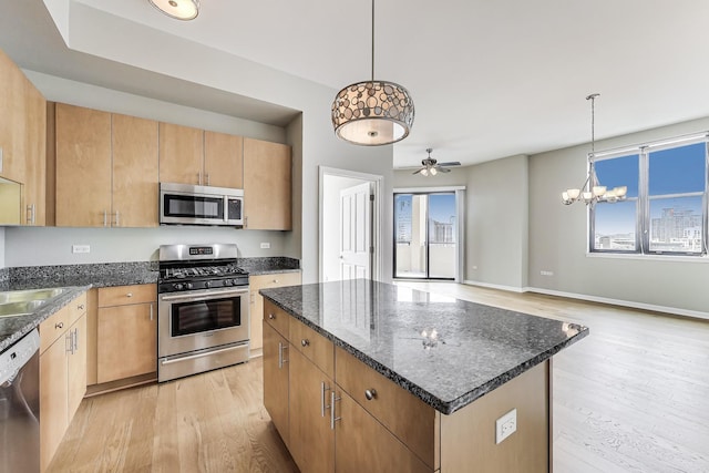 1464 S Michigan Ave Unit 1404, Chicago, IL 60605 - kitchen featuring appliances with stainless steel finishes, light wood finished floors, healthy amount of natural light, and a center island