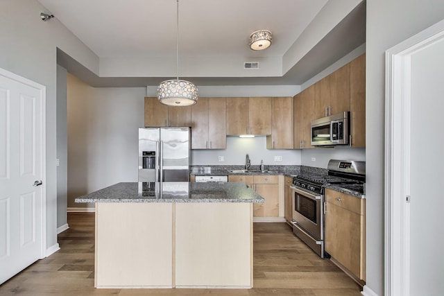 1464 S Michigan Ave Unit 1404, Chicago, IL 60605 - kitchen with appliances with stainless steel finishes, wood finished floors, dark stone counters, a kitchen island, and decorative light fixtures