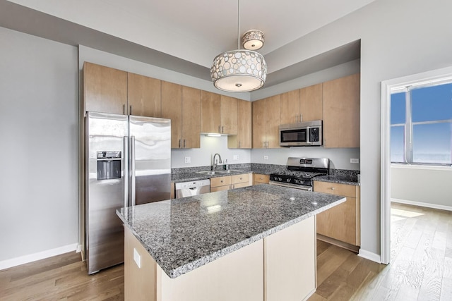 1464 S Michigan Ave Unit 1404, Chicago, IL 60605 - kitchen with appliances with stainless steel finishes, wood finished floors, dark stone countertops, and a kitchen island