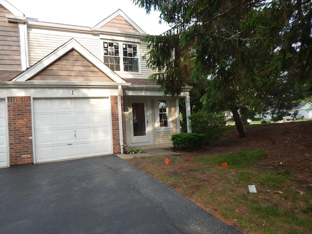1 N Oltendorf Rd, Streamwood, IL 60107 - view of front of property featuring brick siding, asphalt driveway, and a garage