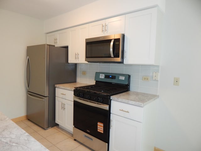 1 N Oltendorf Rd, Streamwood, IL 60107 - kitchen featuring appliances with stainless steel finishes, light countertops, backsplash, and white cabinetry