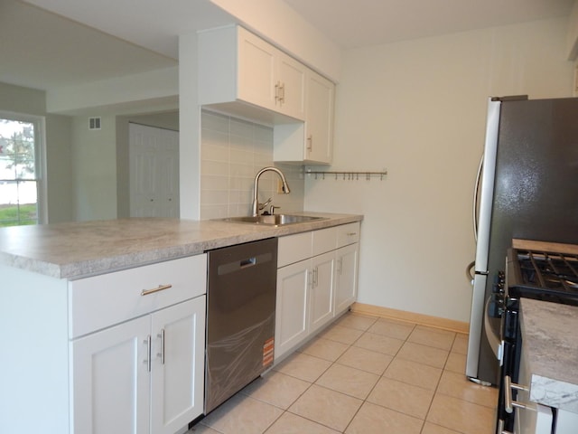 1 N Oltendorf Rd, Streamwood, IL 60107 - kitchen with appliances with stainless steel finishes, a sink, light countertops, tasteful backsplash, and white cabinets