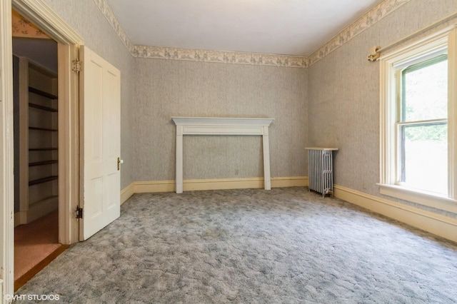 100 E Miller Ave, Hinckley, IL 60520 - unfurnished bedroom featuring multiple windows, radiator heating unit, carpet flooring, and wallpapered walls