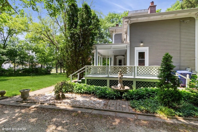 100 E Miller Ave, Hinckley, IL 60520 - back of house featuring a yard, a chimney, and a deck