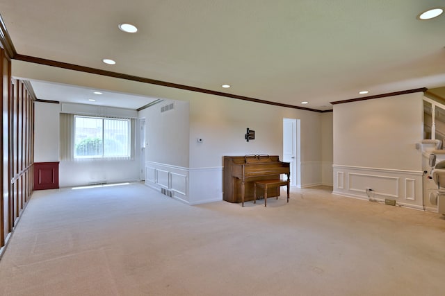 9044 N Clifton Ave, Niles, IL 60714 - living room with a decorative wall, light carpet, crown molding, a wainscoted wall, and recessed lighting