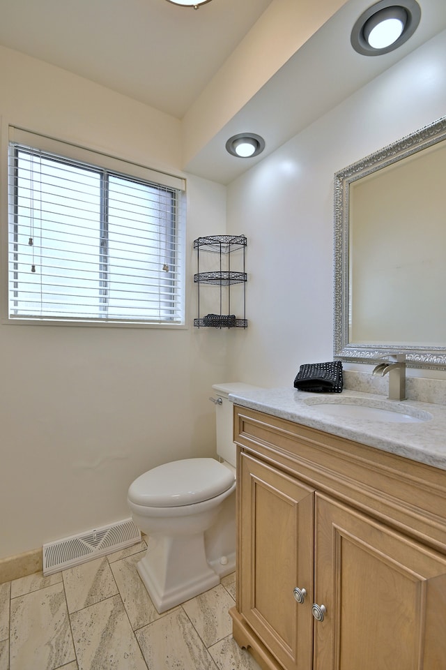 9044 N Clifton Ave, Niles, IL 60714 - bathroom with vanity, toilet, and baseboards