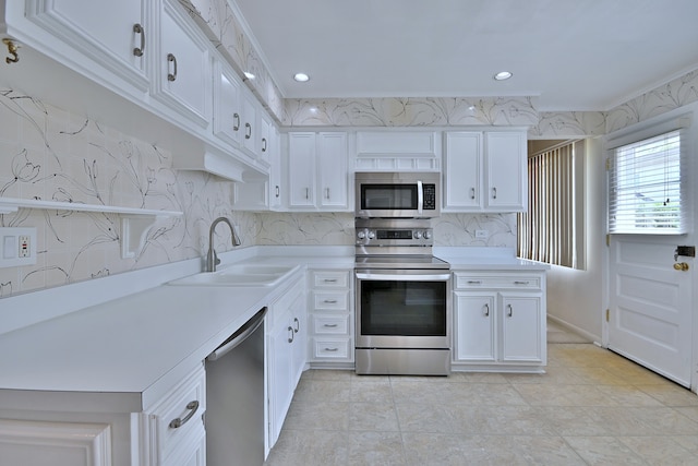9044 N Clifton Ave, Niles, IL 60714 - kitchen with stainless steel appliances, a sink, light countertops, white cabinetry, and recessed lighting