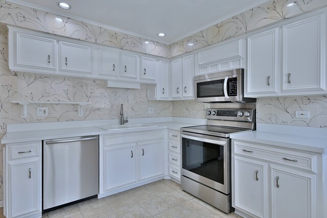 9044 N Clifton Ave, Niles, IL 60714 - kitchen with appliances with stainless steel finishes, a sink, light countertops, white cabinets, and tasteful backsplash