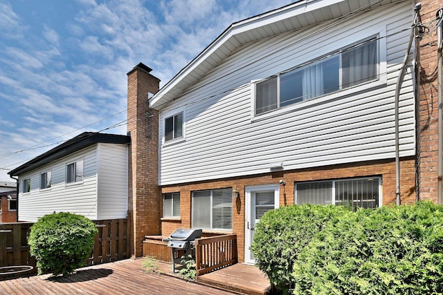 9044 N Clifton Ave, Niles, IL 60714 - rear view of house with a deck and a chimney