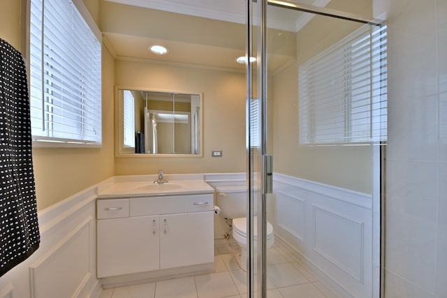 9044 N Clifton Ave, Niles, IL 60714 - bathroom with ornamental molding, toilet, vanity, wainscoting, and an enclosed shower