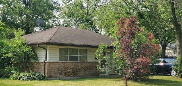 357 Niagara St, Park Forest, IL 60466 - view of front of house with brick siding, a front yard, and a chimney