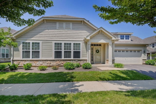 1850 Foxridge Ct, Aurora, IL 60502 - view of front of property featuring driveway, stone siding, a garage, and roof with shingles