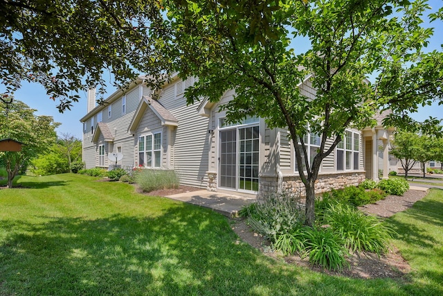 1850 Foxridge Ct, Aurora, IL 60502 - rear view of property featuring a lawn, a chimney, and stone siding