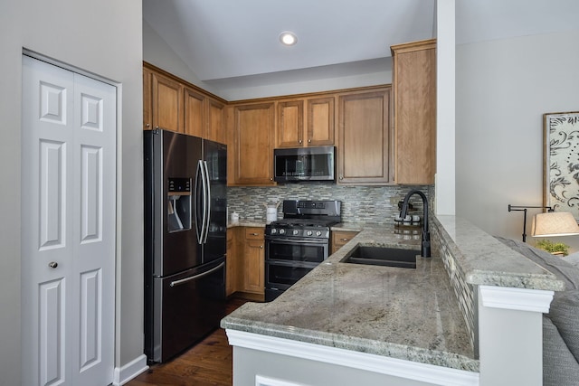 1850 Foxridge Ct, Aurora, IL 60502 - kitchen with stainless steel fridge with ice dispenser, range with two ovens, brown cabinets, light stone counters, and lofted ceiling
