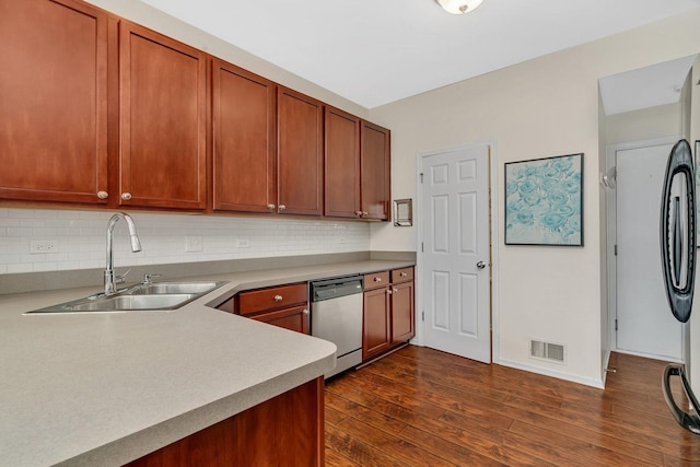 1106 Heron Cir, Joliet, IL 60431 - kitchen with stainless steel dishwasher, a sink, decorative backsplash, dark wood-type flooring, and light countertops