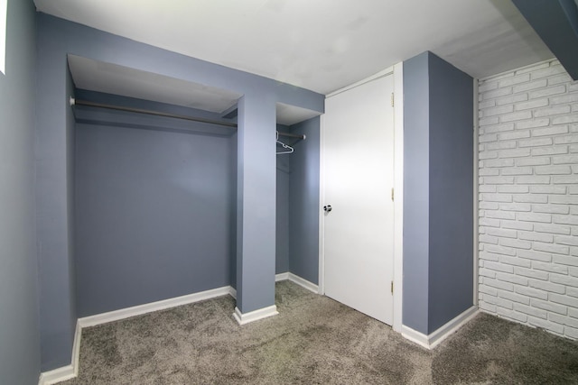 313 Dorsetshire Dr, Steger, IL 60475 - unfurnished bedroom featuring carpet flooring, baseboards, brick wall, and a closet