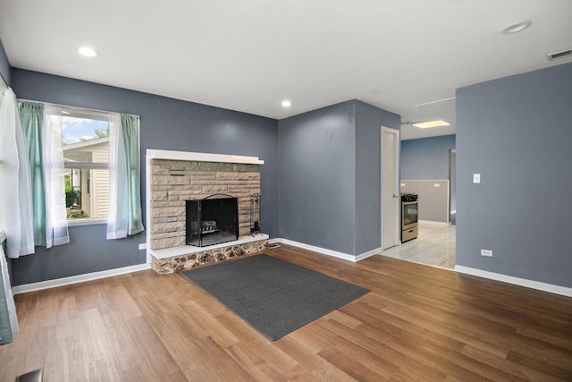 313 Dorsetshire Dr, Steger, IL 60475 - unfurnished living room featuring wood finished floors, a stone fireplace, baseboards, and recessed lighting