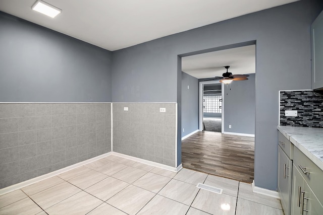 313 Dorsetshire Dr, Steger, IL 60475 - empty room featuring a ceiling fan, tile walls, and light tile patterned flooring