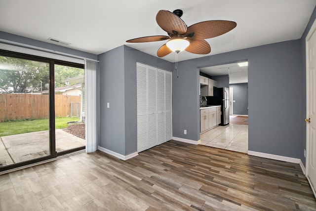 313 Dorsetshire Dr, Steger, IL 60475 - unfurnished bedroom with access to exterior, light wood-style flooring, freestanding refrigerator, and baseboards