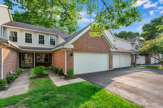 2116 Glasgow Ct, Hanover Park, IL 60133 - traditional home featuring asphalt driveway, an attached garage, brick siding, and roof with shingles