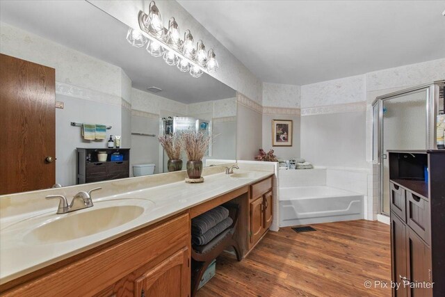 2116 Glasgow Ct, Hanover Park, IL 60133 - full bathroom featuring a bath, a shower stall, double vanity, and wood finished floors