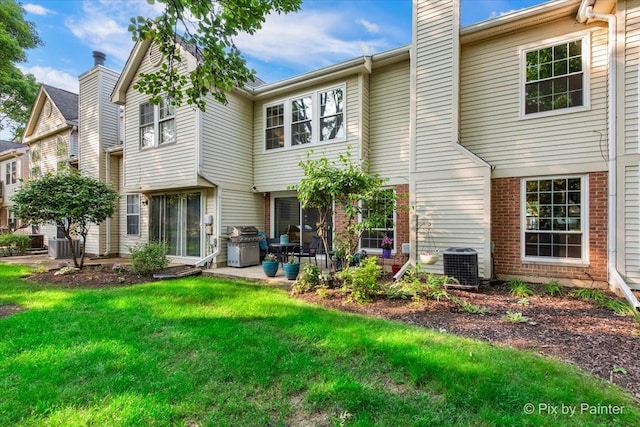2116 Glasgow Ct, Hanover Park, IL 60133 - back of house with a chimney, a patio area, a yard, and brick siding