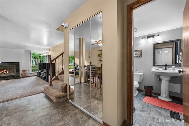 2116 Glasgow Ct, Hanover Park, IL 60133 - interior space featuring stairs, a glass covered fireplace, and a ceiling fan