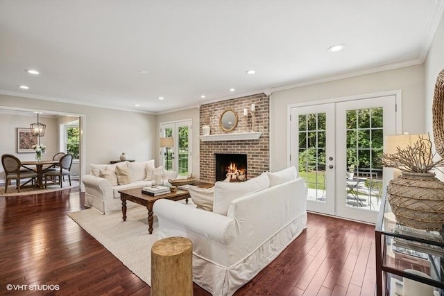 7536 Inverway Dr, Lakewood, IL 60014 - living room with french doors, dark wood-style floors, crown molding, recessed lighting, and a brick fireplace
