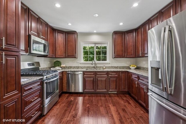 7536 Inverway Dr, Lakewood, IL 60014 - kitchen with stainless steel appliances, dark wood finished floors, light stone countertops, recessed lighting, and ornamental molding