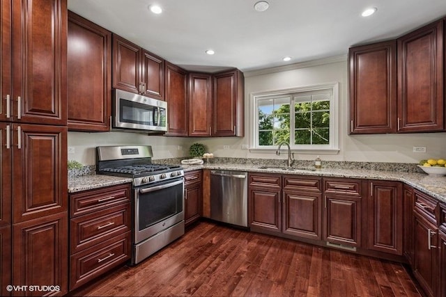 7536 Inverway Dr, Lakewood, IL 60014 - kitchen featuring appliances with stainless steel finishes, dark wood finished floors, light stone counters, ornamental molding, and recessed lighting