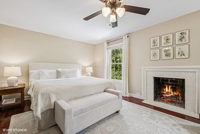 7536 Inverway Dr, Lakewood, IL 60014 - bedroom featuring wood finished floors, a fireplace with flush hearth, and a ceiling fan