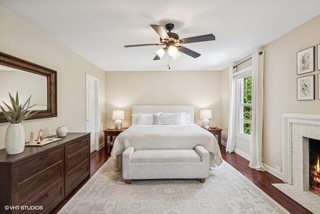 7536 Inverway Dr, Lakewood, IL 60014 - bedroom with a brick fireplace, dark wood finished floors, and ceiling fan