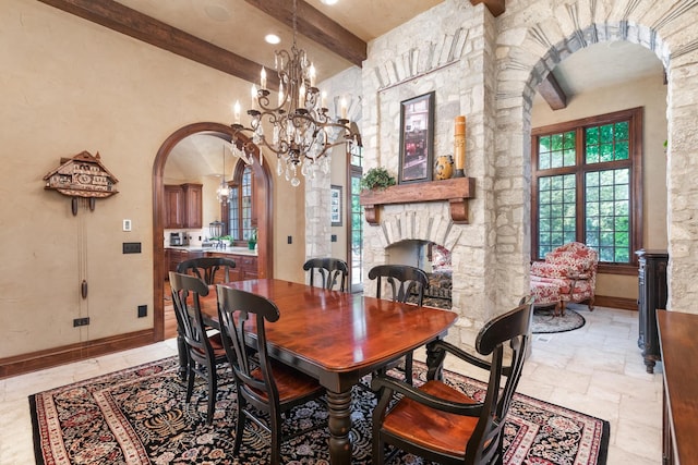 21 Forest Ave, Naperville, IL 60540 - dining area with arched walkways, beamed ceiling, a fireplace, baseboards, and a chandelier