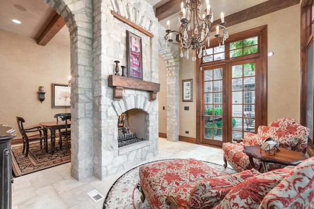 21 Forest Ave, Naperville, IL 60540 - living room with beam ceiling, a chandelier, arched walkways, a stone fireplace, and stone tile flooring