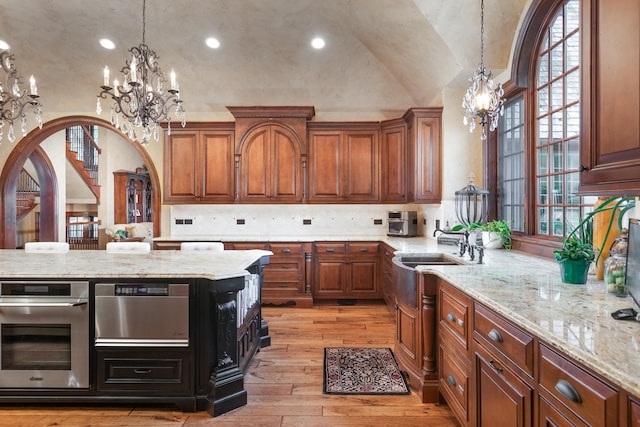 21 Forest Ave, Naperville, IL 60540 - kitchen featuring a chandelier, oven, light wood finished floors, brown cabinets, and vaulted ceiling