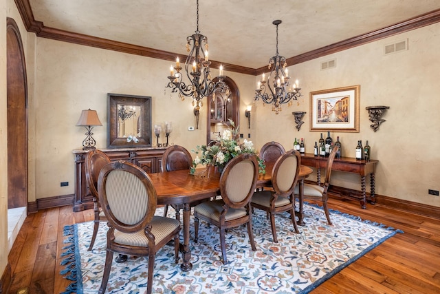21 Forest Ave, Naperville, IL 60540 - dining space featuring a chandelier, wood-type flooring, crown molding, baseboards, and arched walkways
