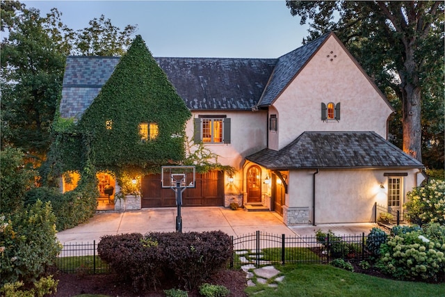 21 Forest Ave, Naperville, IL 60540 - view of front of house featuring stucco siding, concrete driveway, and a fenced front yard