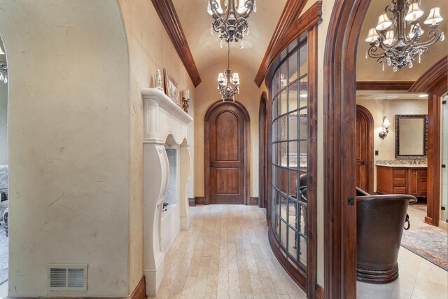 21 Forest Ave, Naperville, IL 60540 - foyer entrance with a chandelier, arched walkways, lofted ceiling, light wood-style flooring, and ornamental molding