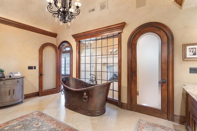 21 Forest Ave, Naperville, IL 60540 - bathroom with a freestanding tub, vanity, a chandelier, baseboards, and tile patterned floors