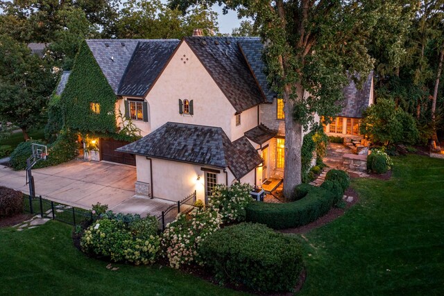 21 Forest Ave, Naperville, IL 60540 - view of front of house with stucco siding, a high end roof, a garage, driveway, and stone siding