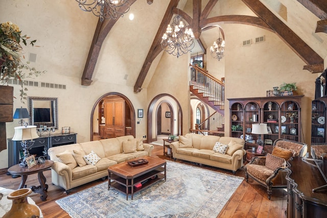 21 Forest Ave, Naperville, IL 60540 - living area featuring a chandelier, arched walkways, high vaulted ceiling, stairs, and beamed ceiling