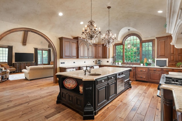 21 Forest Ave, Naperville, IL 60540 - kitchen with vaulted ceiling, a chandelier, a sink, an island with sink, and open floor plan