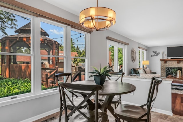 347 Yorkshire Dr, Mundelein, IL 60060 - dining space featuring a chandelier, baseboards, and a brick fireplace
