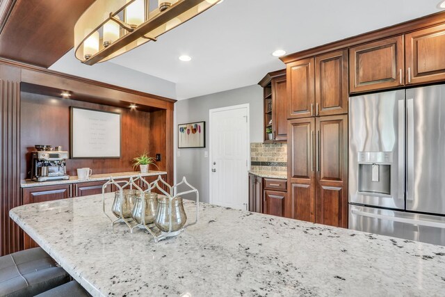 347 Yorkshire Dr, Mundelein, IL 60060 - kitchen featuring stainless steel refrigerator with ice dispenser, light stone counters, recessed lighting, tasteful backsplash, and open shelves