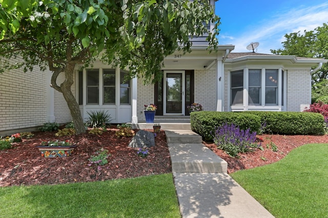 347 Yorkshire Dr, Mundelein, IL 60060 - property entrance with brick siding and a yard