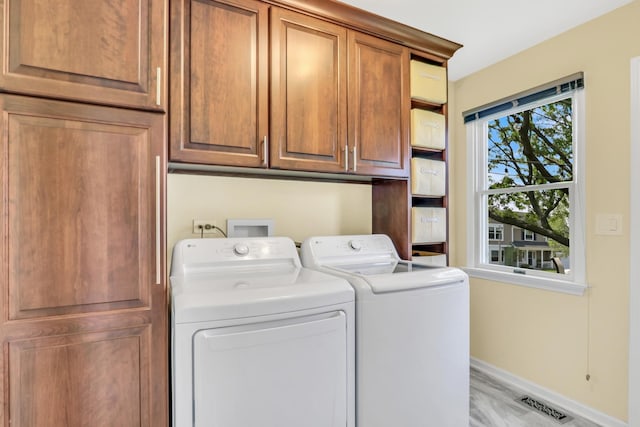 347 Yorkshire Dr, Mundelein, IL 60060 - laundry area featuring separate washer and dryer, cabinet space, and baseboards