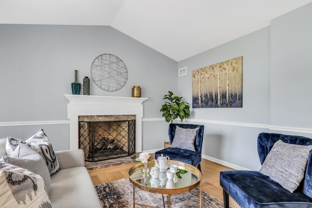 347 Yorkshire Dr, Mundelein, IL 60060 - living room featuring lofted ceiling, a fireplace with raised hearth, wood finished floors, and baseboards