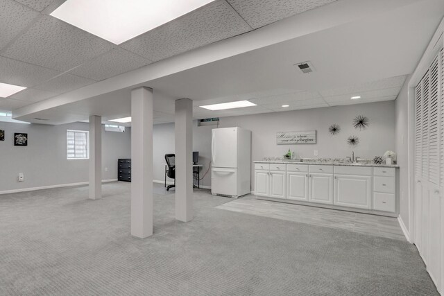 347 Yorkshire Dr, Mundelein, IL 60060 - below grade area featuring freestanding refrigerator, light colored carpet, bar with sink, a paneled ceiling, and baseboards