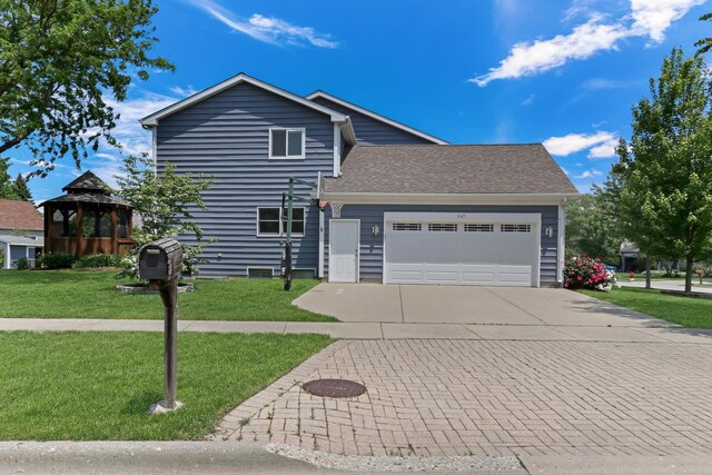 347 Yorkshire Dr, Mundelein, IL 60060 - view of front facade with driveway, an attached garage, a front lawn, a gazebo, and a shingled roof
