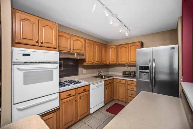 400 E Randolph St Unit 1825, Chicago, IL 60601 - kitchen featuring white appliances, a warming drawer, light countertops, light tile patterned floors, and under cabinet range hood